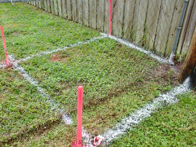 Boundary survey markers showing a fence near a residential property line dispute